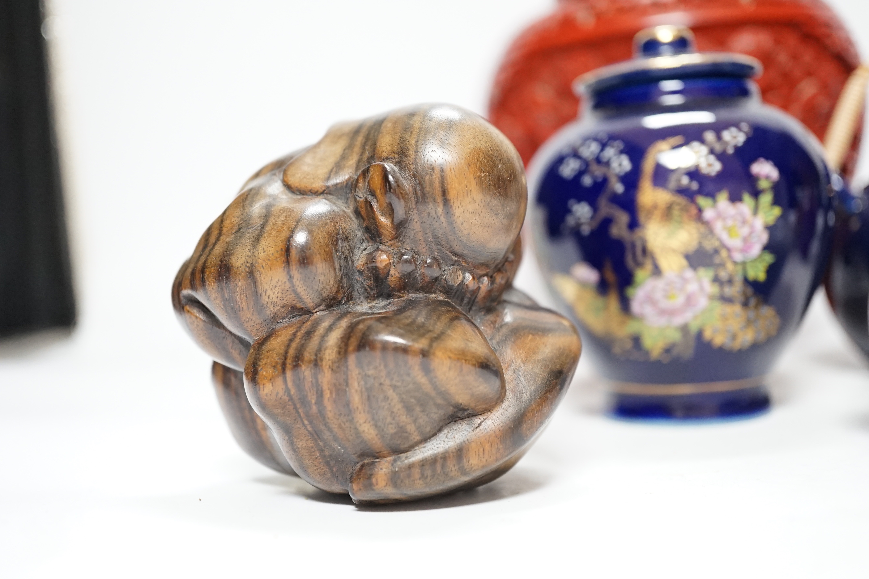 A Chinese cinnabar lacquer jar and cover, a Chinese copper red bottle vase, a carved wood figure, a Meissen miniature bowl and other ceramics, jar 15cm